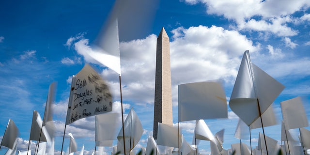 People visit the 'In America: Remember' public art installation near the Washington Monument on the National Mall on Monday, Sept. 20, 2021 in Washington, D.C. 