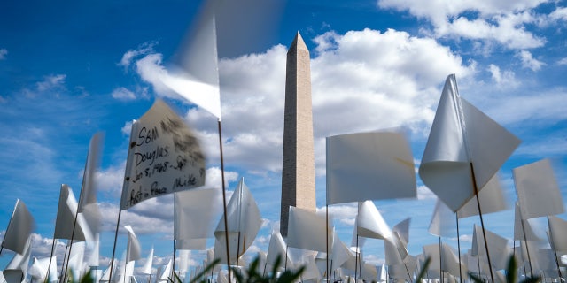 People visit the 'In America: Remember' public art installation near the Washington Monument on the National Mall on Monday, Sept. 20, 2021 in Washington, D.C.