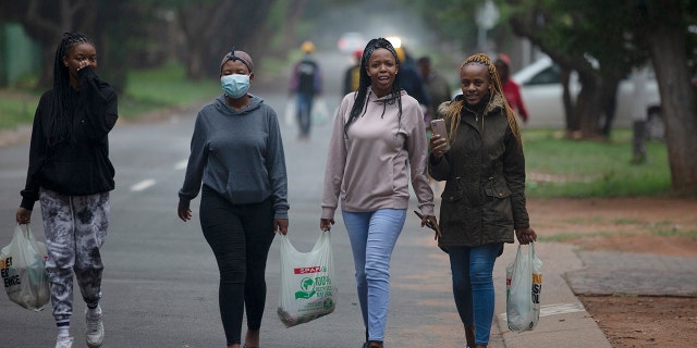 Students from the Tshwane University of Technology make their way back to their residence in Pretoria, South Africa, on Saturday, Nov. 27, 2021. The world is racing to contain a new COVID-19 variant, which appears to be driving a surge in South Africa and is casting a pall there.