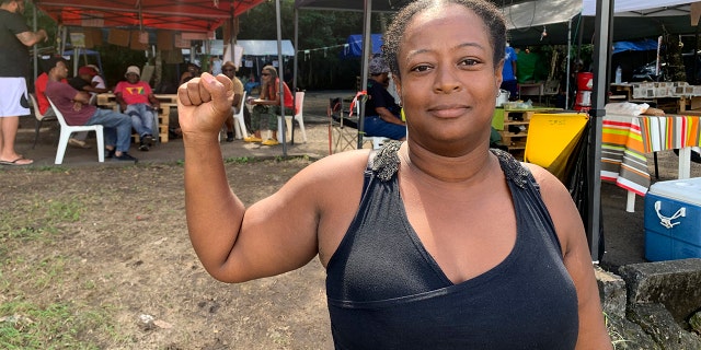 Marylis Colzin, a nurse protesting France's mandatory vaccinations for health care workers, poses in Pointe-a-Pitre, Guadeloupe island, on Sunday, Nov. 21, 2021.