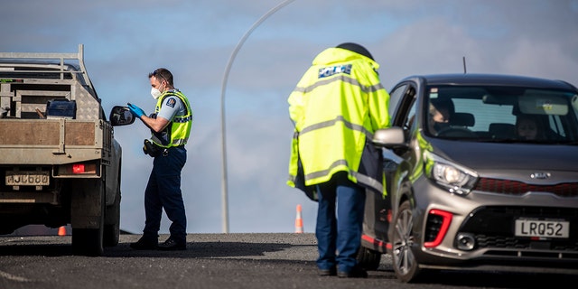 Police inspect vehicles at a road block on the outskirts of Auckland, New Zealand on Sept. 30, 2021. 