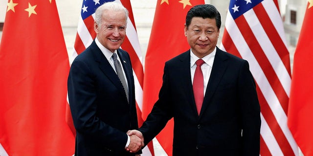 FILE PHOTO: Chinese President Xi Jinping shakes hands with U.S. Vice President Joe Biden (L) inside the Great Hall of the People in Beijing December 4, 2013.