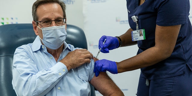 Dr. Richard Schwartz receives COVID-19 Pfizer vaccine booster at Teaching Center LIJ Medical Center. The COVID-19 booster shots have the same recipe as the original vaccines.