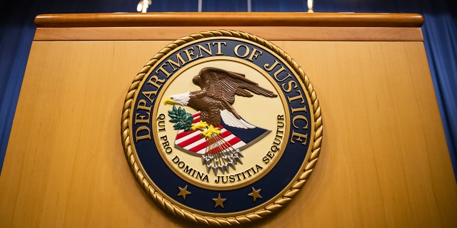 The U.S. Department of Justice seal on a podium in Washington, D.C.