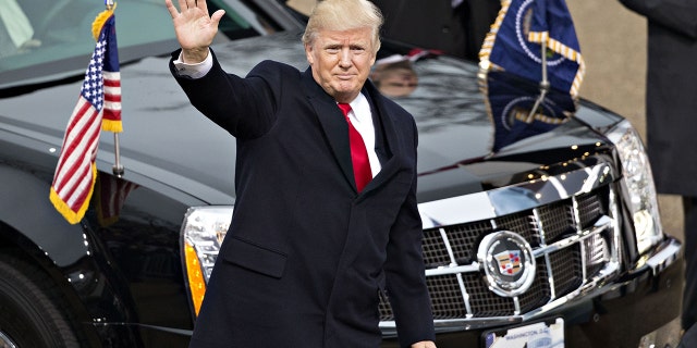 Then-U.S. President Donald Trump waves while walking near the White House during the 58th presidential inauguration parade in Washington, D.C., U.S., on Friday, Jan. 20, 2017.