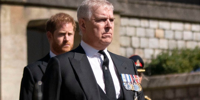 Prince Andrew, foreground, walks in the procession ahead of Britain Prince Philip's funeral at Windsor Castle, Windsor, England, April 17, 2021.