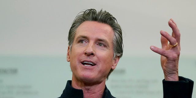 FILE - Gov. Gavin Newsom speaks at a news conference in Oakland, Calif., on Oct. 27, 2021. Gov. Newsom has changed plans and won't be going to the upcoming United Nations Climate Change Conference in Glasgow, Scotland. Newsom's office cited 