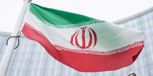 The flag of Iran waves in front of the International Center building with the headquarters of the International Atomic Energy Agency in Vienna, AustriaI, May 24, 2021.