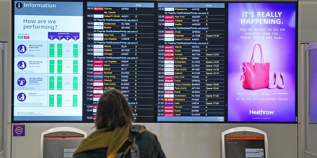 A passenger looks at a departures board at London Heathrow Airport's T3 as the US reopens its borders to UK visitors in a significant boost to the travel sector in London on Monday.