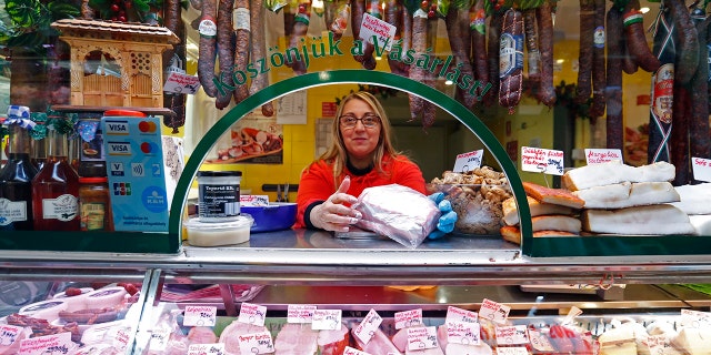 A vendor sells food items at a food market in Budapest, Hungary, on Nov. 20, 2021. 