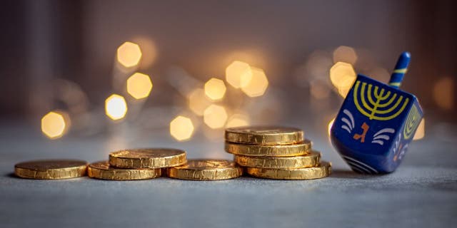 Dreidels and chocolate coins are often given to children during Hanukkah celebrations.