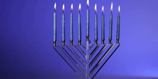 Hanukkah menorahs have eight candle arms to represent the eight nights the Second Temple's oil lamp burned. The middle candle arm, which is technically the ninth, is reserved for the helper candle. 