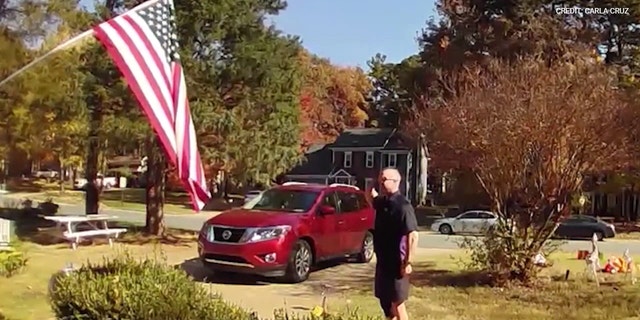 FedEx driver recorded picking up a fallen American flag and saluting it outside a home in Matthews, North Carolina. 