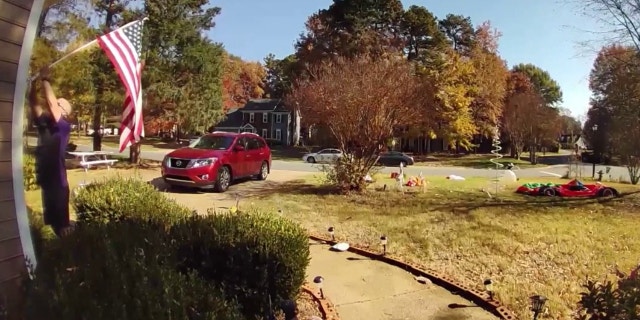 FedEx driver recorded picking up a fallen American flag and saluting it outside a home in Matthews, North Carolina.
