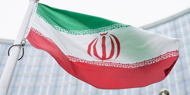 The flag of Iran waves in front of the International Center building with the headquarters of the International Atomic Energy Agency, in Vienna, May 24, 2021.