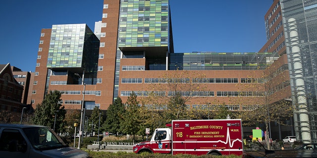 A Baltimore County Fire Department ambulance travels past the entrance of The Johns Hopkins Hospital in Baltimore, Maryland, on Friday, Nov. 20, 2020. Dr. Eric Kossoff from John Hopkins in Balitmore helped one family whose daughter suffers from epilepsy.