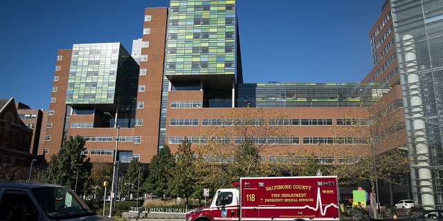 A Baltimore County Fire Department ambulance travels past the entrance of The Johns Hopkins Hospital in Baltimore, Maryland, on Friday, Nov. 20, 2020. Dr. Eric Kossoff from John Hopkins in Balitmore helped one family whose daughter suffers from epilepsy.