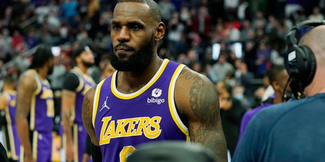 Los Angeles Lakers forward LeBron James is ejected after fouling Detroit Pistons center Isaiah Stewart during the second half of an NBA basketball game in Detroit. (AP Photo/Carlos Osorio)