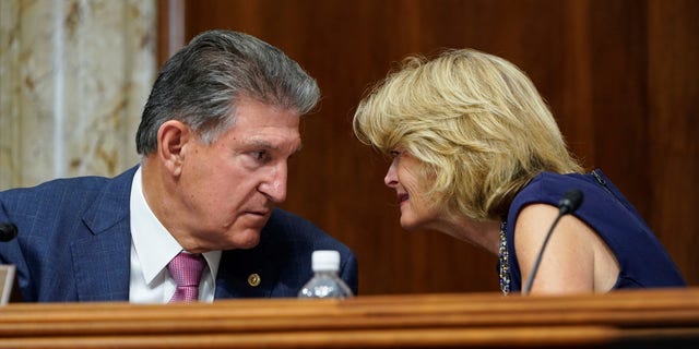 Chairman of the Senate Committee on Energy and Natural Resources Joe Manchin (D-WV) speaks with Senator Lisa Murkowski (R-AK) during a hearing on Capitol Hill in Washington, U.S., July 27, 2021. REUTERS/Joshua Roberts