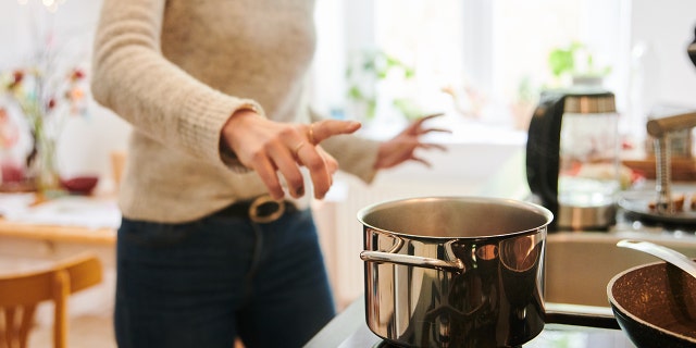 This photo shows a mother jumping to the hot pot in the kitchen. Recently, one family's kitchen became their pharmacy as their daughter tried a keto diet to help with her epilepsy.