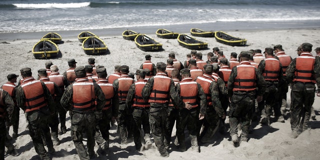A group of Navy SEAL trainees in August 2010 during Hell Week at a beach in Coronado, California.