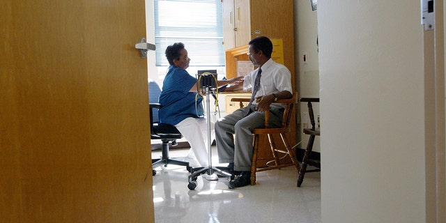 Nurse Melba Benedict (L) checks Negash Berhe's blood pressure July 9, 2003 at Highland Hospital in Oakland, California. Recently, reports show that nearly one-fifth of adults with hypertension are taking medication that increases blood pressure.