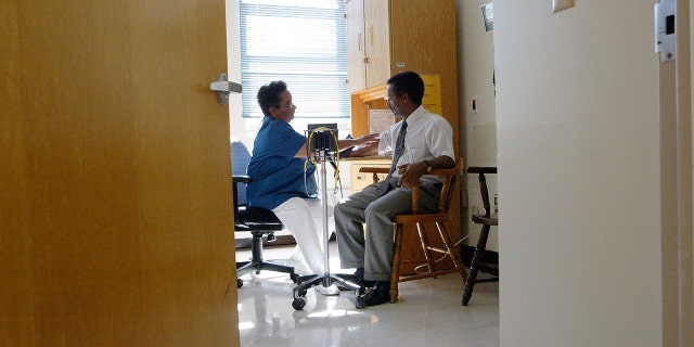 Nurse Melba Benedict (L) checks Negash Berhe's blood pressure July 9, 2003 at Highland Hospital in Oakland, California. Recently, reports show that nearly one-fifth of adults with hypertension are taking medication that increases blood pressure.