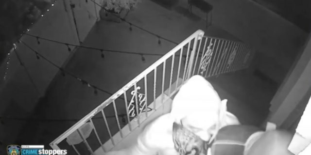 Two male suspects were seen on video repeatedly punching the father in the face while trying to force themselves in, according to police.