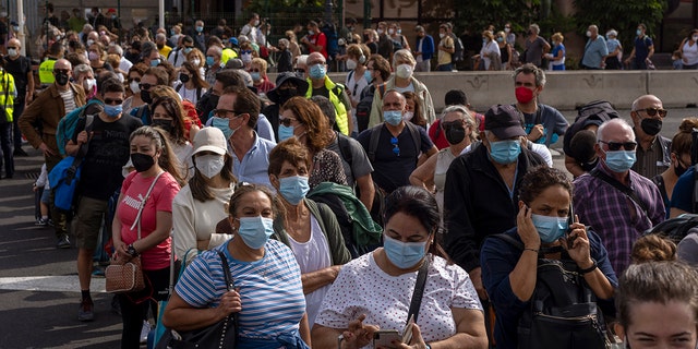 Passengers line up as they try to board a ferry at the port in the Canary island of La Palma, Spain, on Wednesday.