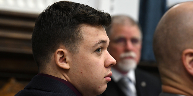 Kyle Rittenhouse looks on as John Black, use-of-force expert, testifies during Kyle Rittenhouse's trial at the Kenosha County Courthouse in Kenosha, Wisconsin, Nov. 11, 2021.