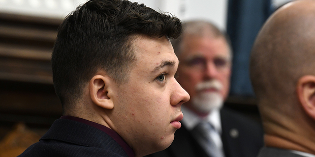 Kyle Rittenhouse looks on as John Black, use-of-force expert, testifies during Kyle Rittenhouse's trial at the Kenosha County Courthouse in Kenosha, Wisconsin, Nov. 11, 2021.