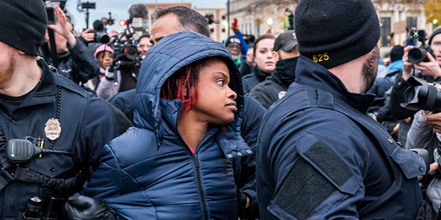 Kenosha Police arrest Shaquita Cornelious, 34, who is in favor of conviction in front of the Kenosha County Courthouse while the jury deliberates the Kyle Rittenhouse trial on November 17, 2021 in Kenosha, Wisconsin.