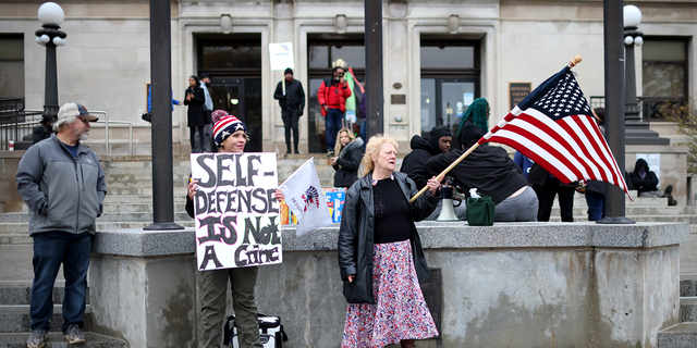 KENOSHA, WISCONSIN - NOVEMBER 17: Demonstrators gather outside of the Kenosha County Courthouse as the jury deliberates for a second day in the trial of Kyle Rittenhouse on November 17, 2021 in Kenosha, Wisconsin. Rittenhouse, a teenager, faces homicide charges and other offenses in the fatal shootings of Joseph Rosenbaum and Anthony Huber and for shooting and wounding of Gaige Grosskreutz during unrest in Kenosha that followed the police shooting of Jacob Blake in August 2020. (Photo by Scott Olson/Getty Images)