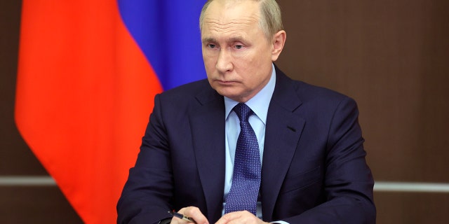 Russian President Vladimir Putin attends a Cabinet meeting via video link in the Black Sea resort of Sochi, Russia, Wednesday, Nov. 24, 2021.