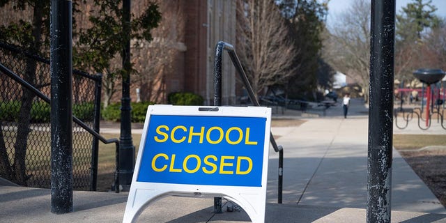 A "firm" sign outside a public elementary school in Grand Rapids, Michigan, in March 2020. Michigan has closed all schools in a bid to thwart the spread of the novel coronavirus.