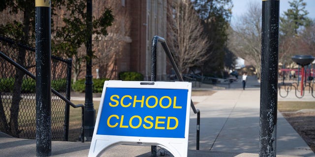 A "closed" sign in front of a public elementary school in Grand Rapids, Michigan, in March 2020. Michigan closed all schools in an effort to thwart the spread of the novel coronavirus.