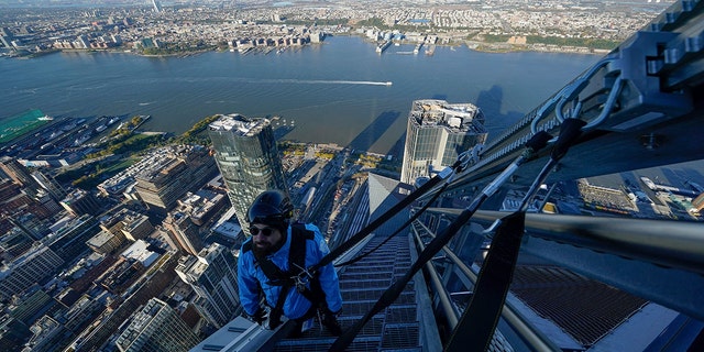 Maintenance technician Enzo Gentile helps escort a group of journalists to the top of the new City Climb attraction at 30 Hudson Yards in New York on Nov. 3.