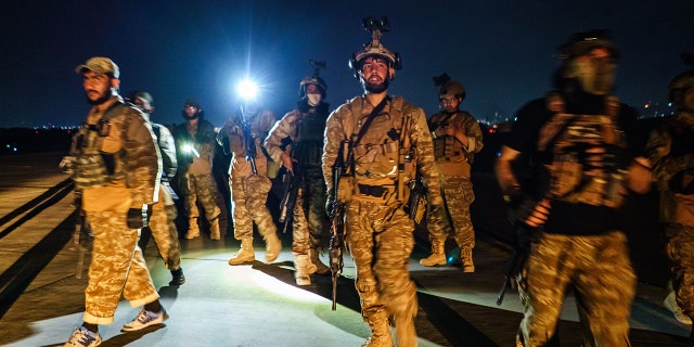 Taliban fighters from the Fateh Zwak unit, wielding American supplied weapons, equipment and uniforms, storm into the Kabul International Airport to secure the airport and inspect the equipment that was left behind after the U.S. military completed their withdrawal, in Kabul, Afghanistan, in August.
