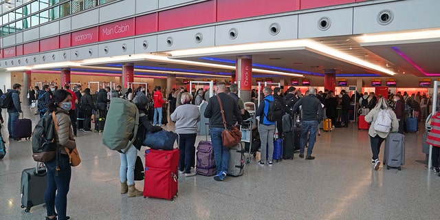 Passengers queue at London Heathrow Airport's T3 as the US reopens its borders to UK visitors in a significant boost to the travel sector in London on Monday.