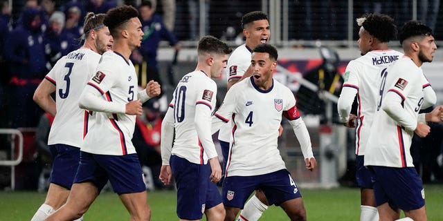 United States forward Christian Pulisic, #10, celebrates with teammate Tyler Adams, #4, after scoring a goal during the second half of a FIFA World Cup qualifying soccer match against Mexico, Friday, November 12. 2021, in Cincinnati.