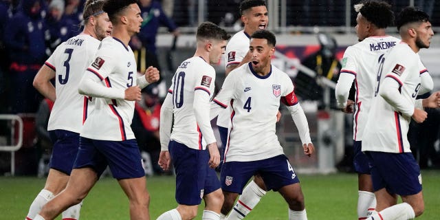U.S. forward Christian Pulisic, #10, celebrates with teammate Tyler Adams, #4, after scoring a goal during the second half of a FIFA World Cup qualifying soccer match against Mexico, Friday, Nov. 12, 2021, in Cincinnati.
