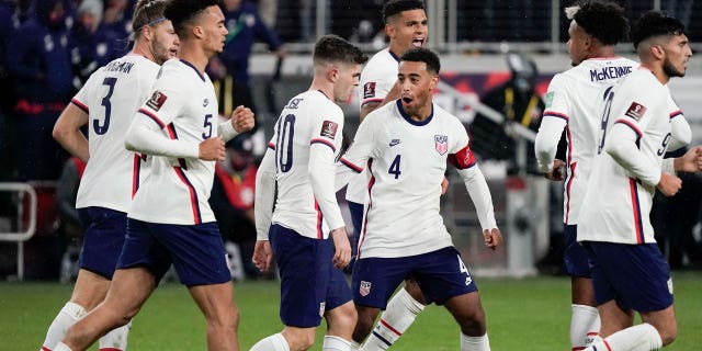 United States forward Christian Pulisic, #10, celebrates with teammate Tyler Adams, #4, after scoring a goal during the second half of a FIFA World Cup qualifying soccer match against Mexico, Friday, November 12. 2021, in Cincinnati.