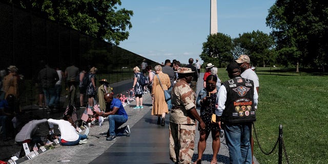 Veterans and others pay their respects at the Vietnam Veterans Memorial in Washington May 31, 2021.
