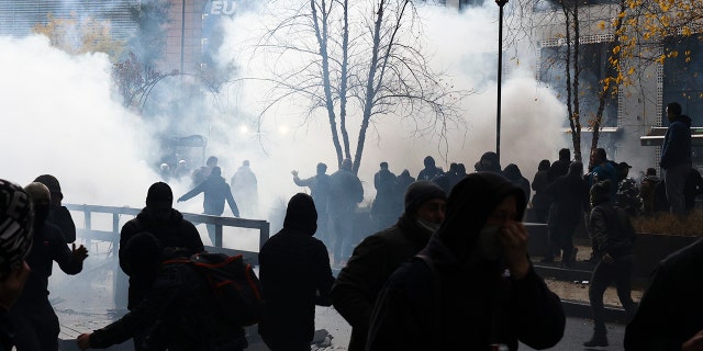 A protestors clash with riot police during a demonstration against the reinforced measures of the Belgium government to counter the latest spike of the coronavirus in Brussels, Belgium, Sunday, Nov. 21, 2021.