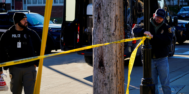 Police officers close a street in downtown Waukesha the morning after a car plowed through a holiday parade in Waukesha, Wisconsin, U.S., November 22, 2021.