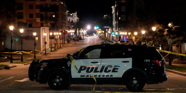 A police car is seen at Main Street in downtown Waukesha after a car plowed through a holiday parade in Waukesha, Wisconsin, on Nov. 22, 2021.  REUTERS/Cheney Orr