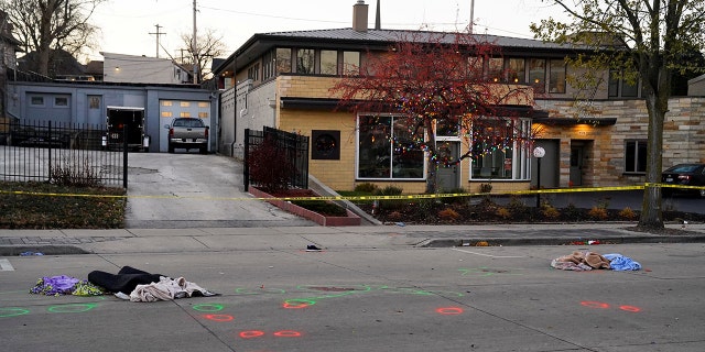 Crime scene evidence circled in spray paint is seen on Main Street the morning after a car plowed through a holiday parade in Waukesha, Wisconsin.