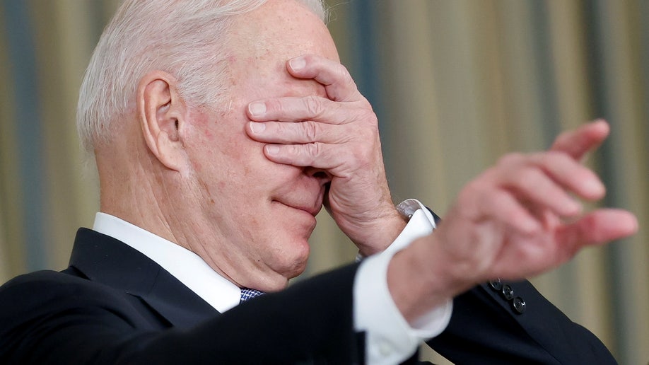 President Biden covers his face and calls on a reporter after delivering remarks on the passage of a $1 trillion infrastructure bill. 
