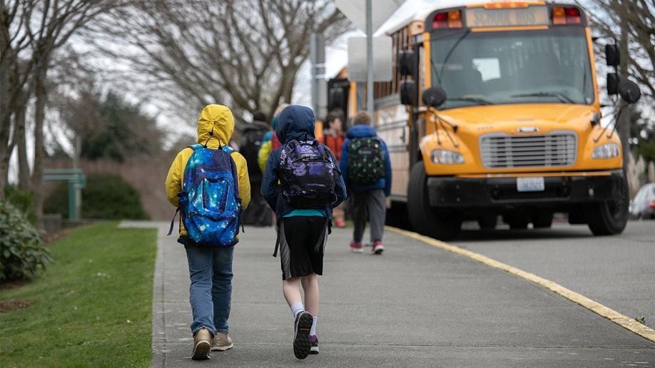 Seattle Public School students are seen near a bus in 2020