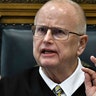 KENOSHA, WISCONSIN - NOVEMBER 10:  Judge Bruce Schroeder, reprimands Assistant District Attorney Thomas Binger in his conduct in line of questioning while cross-examining Kyle Rittenhouse during the Kyle Rittenhouse trial at the Kenosha County Courthouse on November 10, 2021 in Kenosha, Wisconsin. Rittenhouse is accused of shooting three demonstrators, killing two of them, during a night of unrest that erupted in Kenosha after a police officer shot Jacob Blake seven times in the back while being arrested in August 2020. Rittenhouse, from Antioch, Illinois, was 17 at the time of the shooting and armed with an assault rifle. He faces counts of felony homicide and felony attempted homicide. (Photo by Sean Krajacic-Pool/Getty Images)